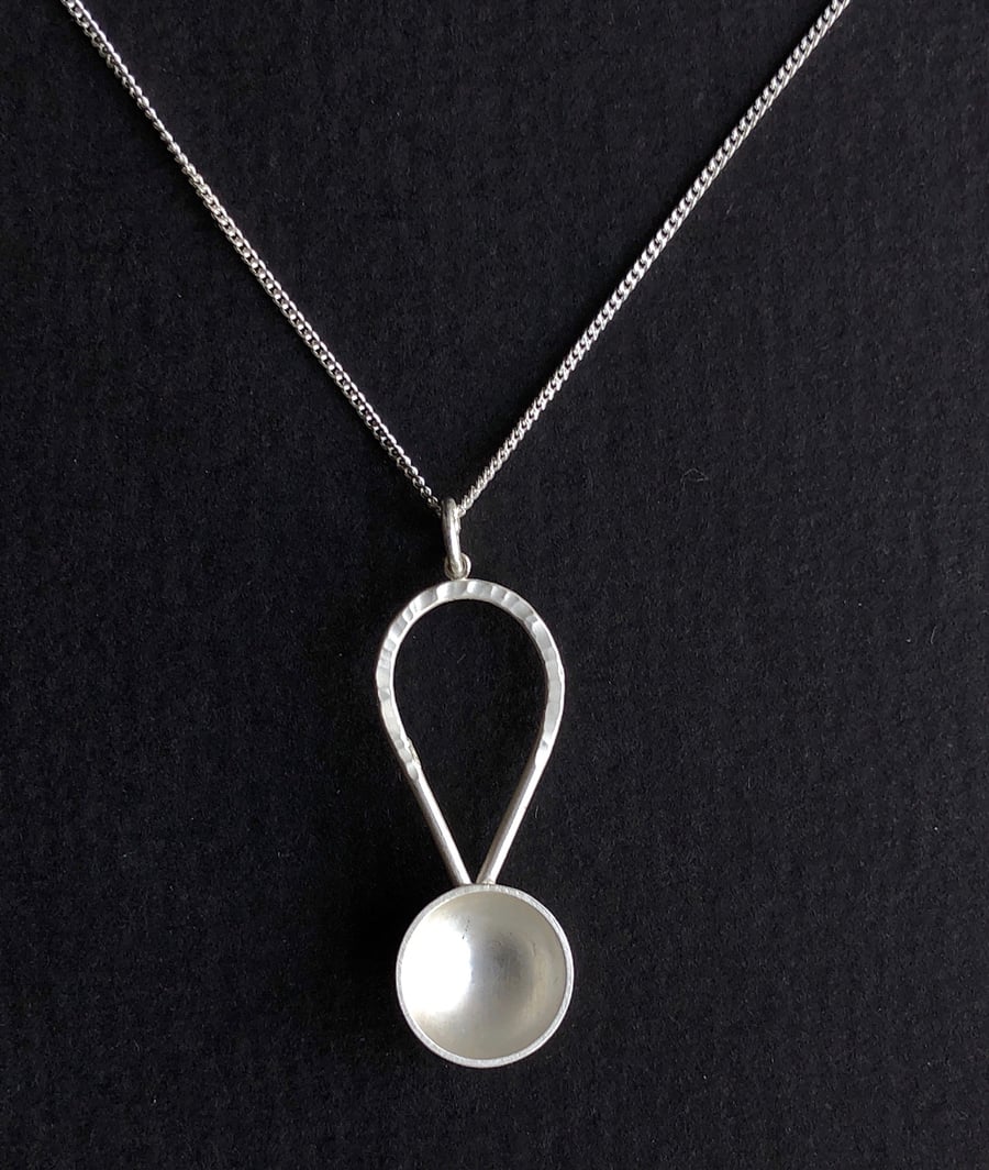 Sterling silver abstract spoon pendant with hammered detail.