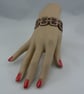 Pyrographed leather bracelet featuring chain design - Image 1