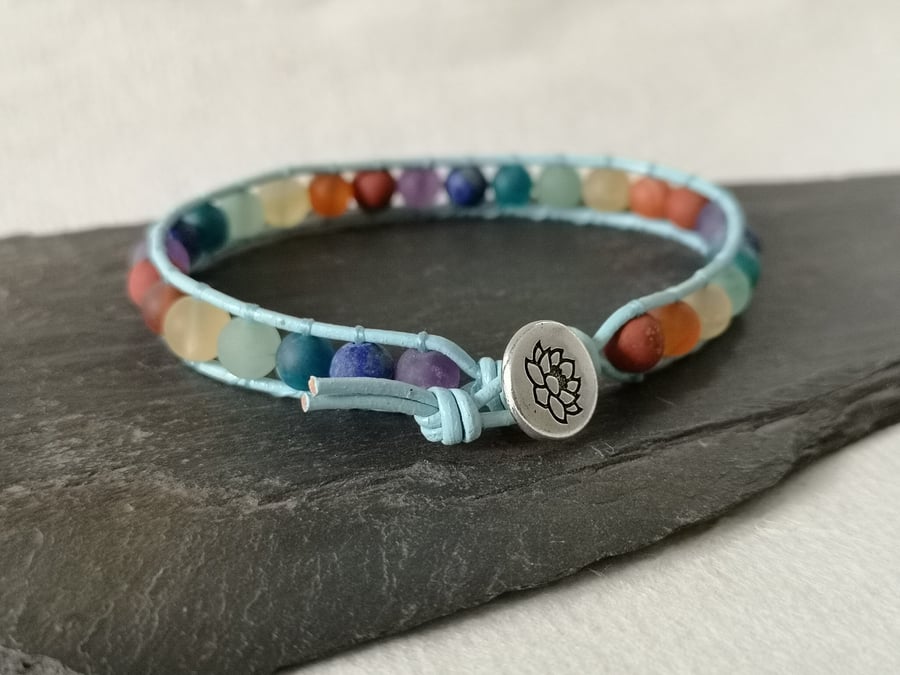 Chakra matt gemstone bead and blue leather bracelet with lotus flower button