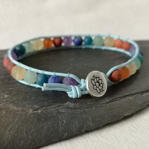 Chakra matt gemstone bead and blue leather bracelet with lotus flower button