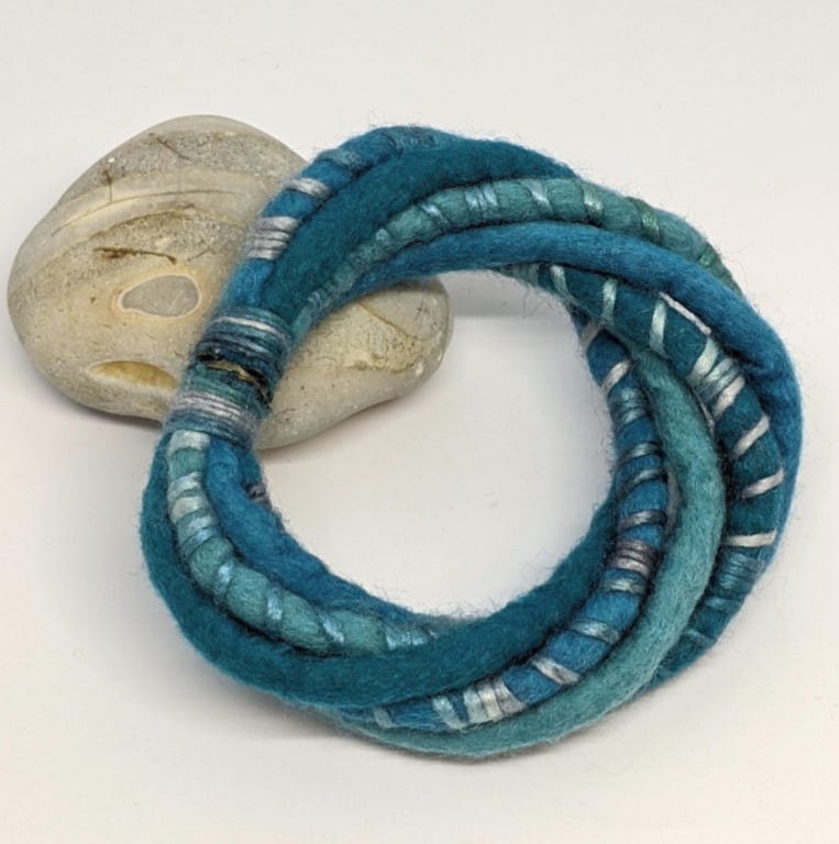 Felted cord bracelet in shades of turquoise