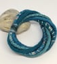 Felted cord bracelet in shades of turquoise