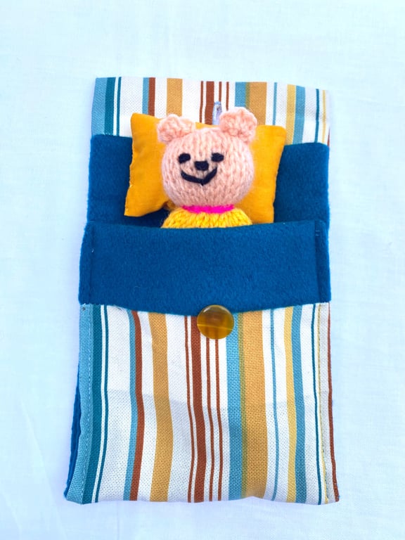 Hand knitted mini bear in bed