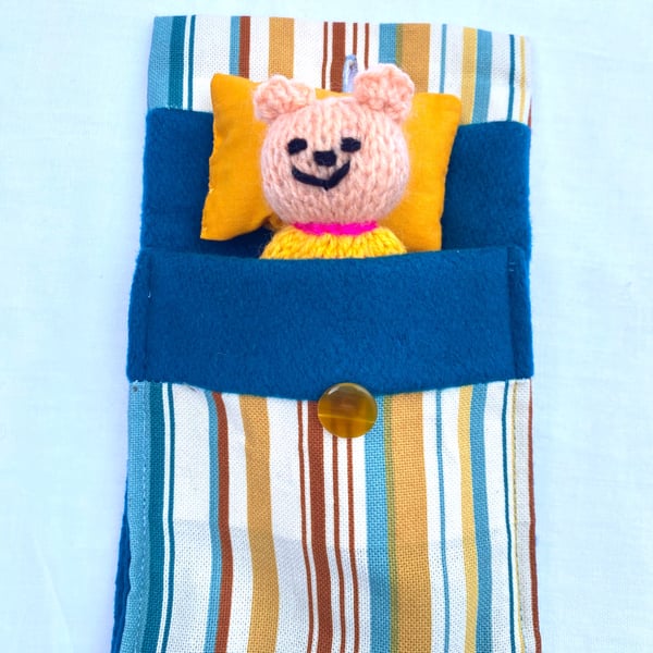 Hand knitted mini bear in bed