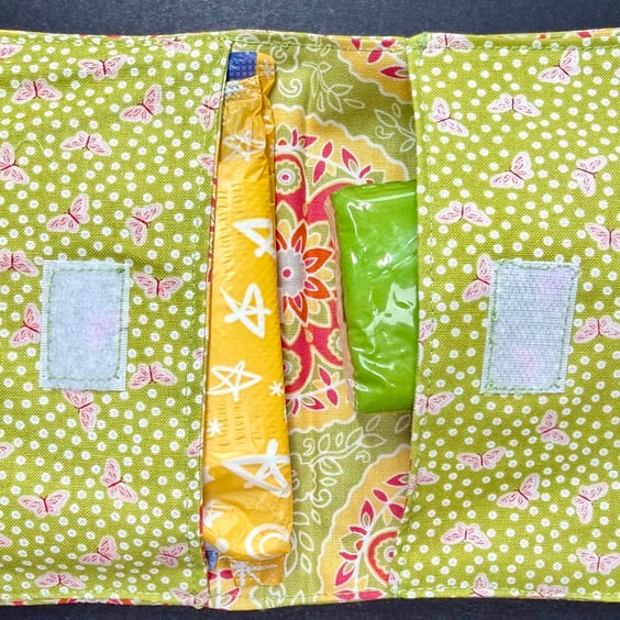 Discrete privacy pack with red and white butterfly cotton outer on green