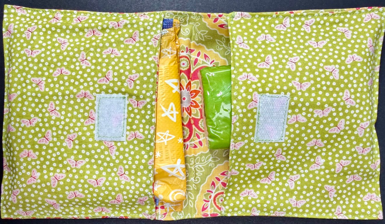 Discrete privacy pack with red and white butterfly cotton outer on green