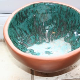 Handmade ceramic terracotta footed glazed metallic green bowl