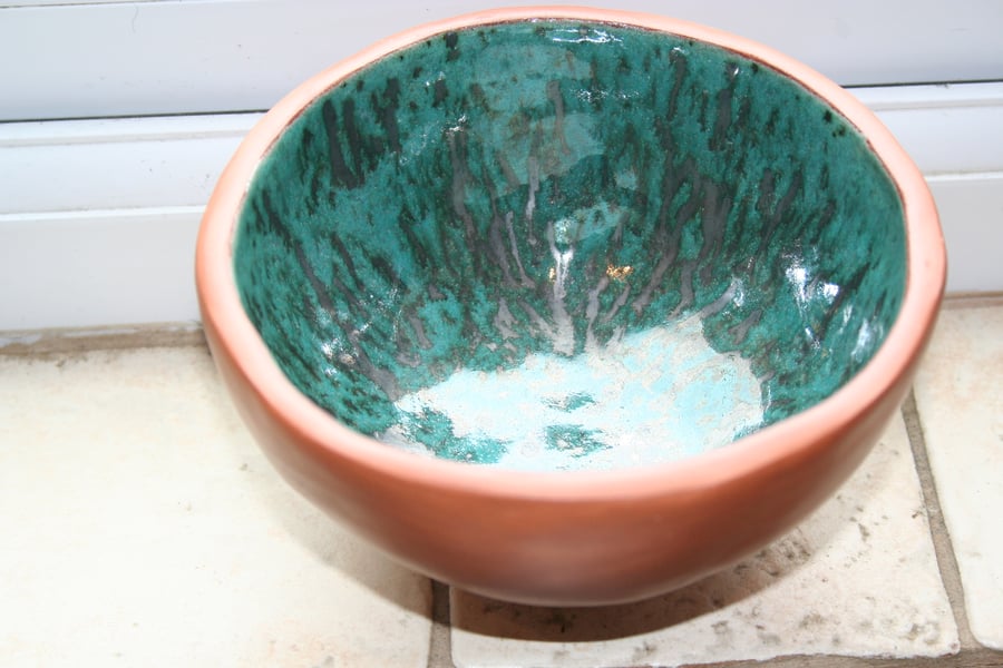 Handmade ceramic terracotta footed glazed metallic green bowl