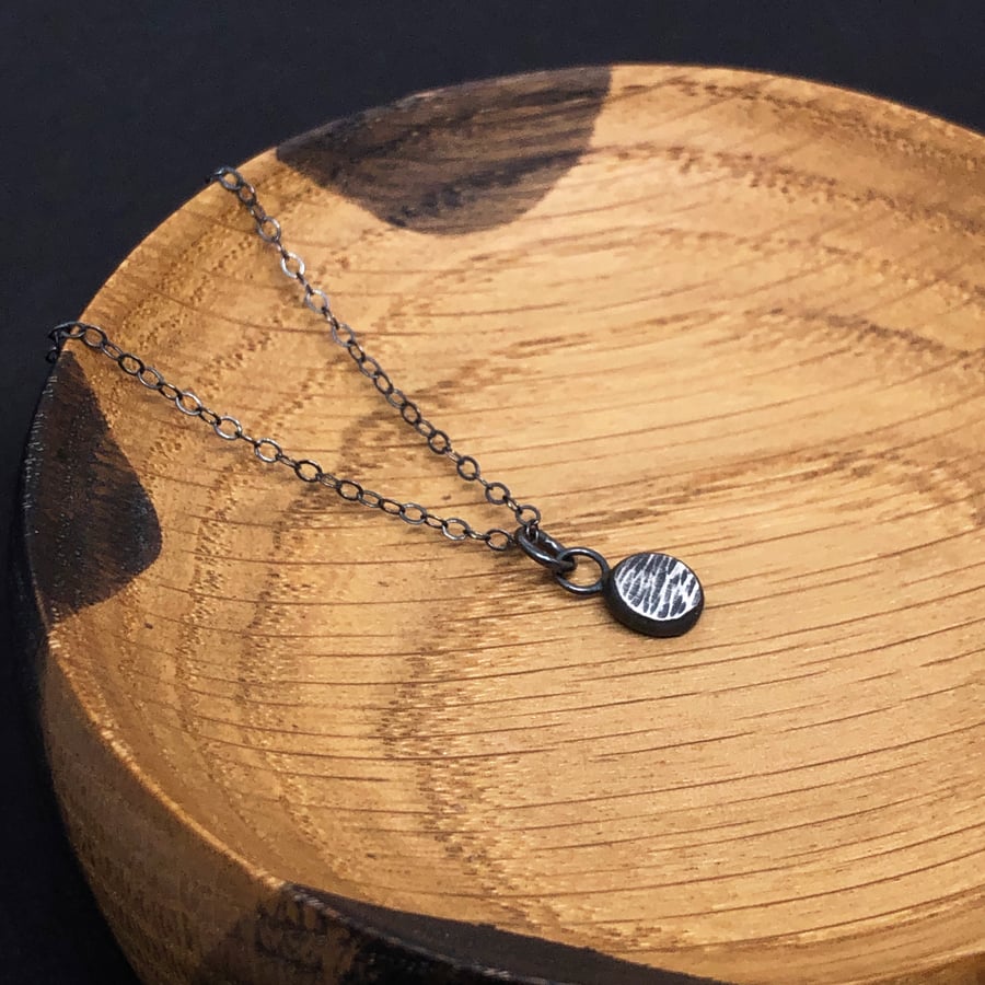 Hammered and oxidised silver pendant on oxidised silver chain. Recycled silver.