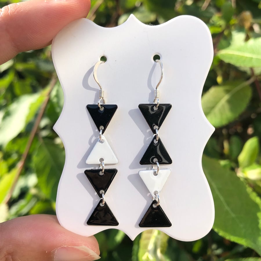 Topsy-turvy Hand enamel earrings. Black and white enamel earrings. 