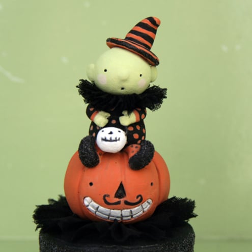 Primitive folk art Halloween baby witch on a pumpkin