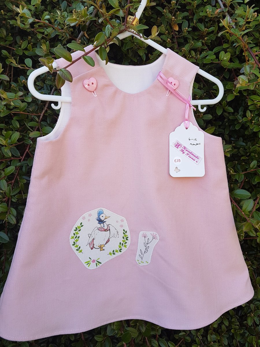 Age: 6-12m. Pale pink baby needlecord pinafore dress. 