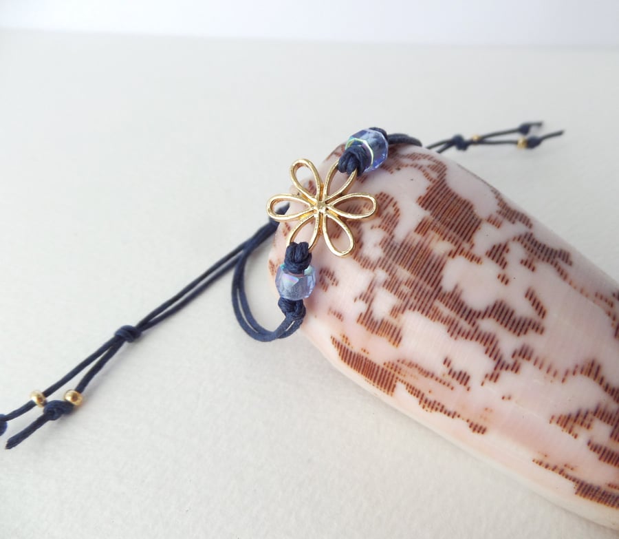 Gold Flower Bracelet, Navy Blue Adjustable Cord, with faceted crystals.