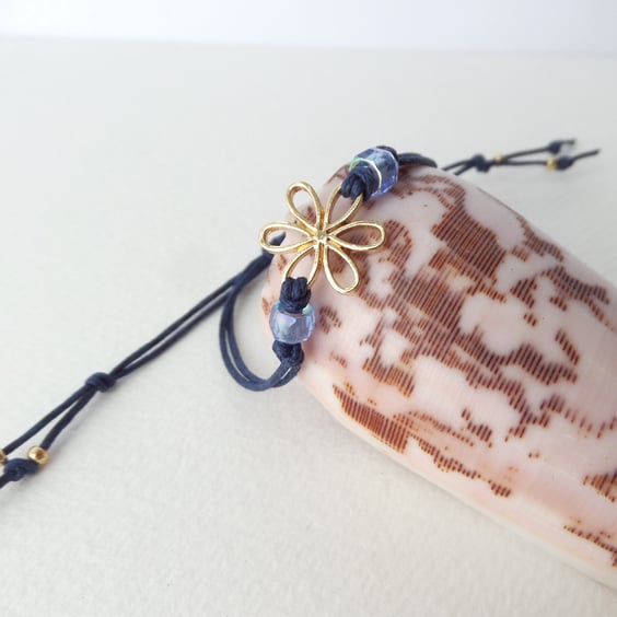 Gold Flower Bracelet, Navy Blue Adjustable Cord, with faceted crystals.