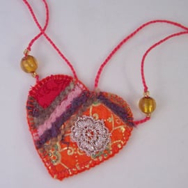 Embroidered love heart textile necklace in fiery oranges