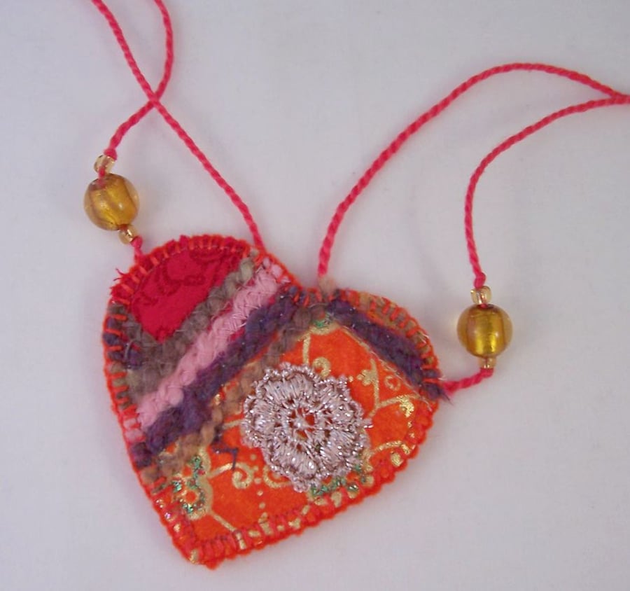 Embroidered love heart textile necklace in fiery oranges
