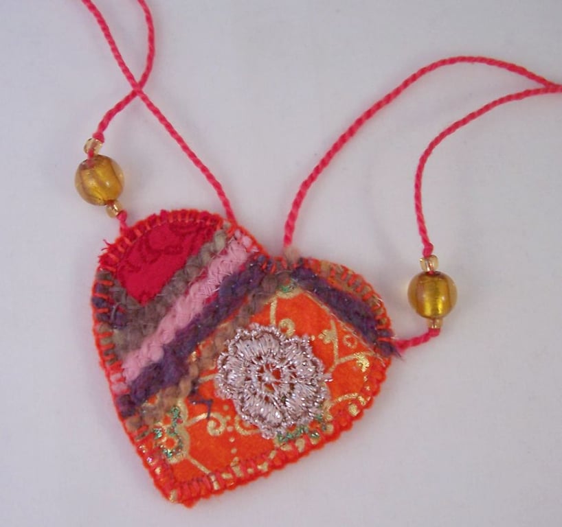 Embroidered love heart textile necklace in fiery oranges