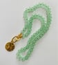 Minty green glass rondelle necklace with celestial pendant