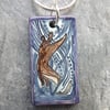 Handmade Ceramic Otter pendant in turquoise blue and purple
