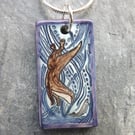 Handmade Ceramic Otter pendant in turquoise blue and purple