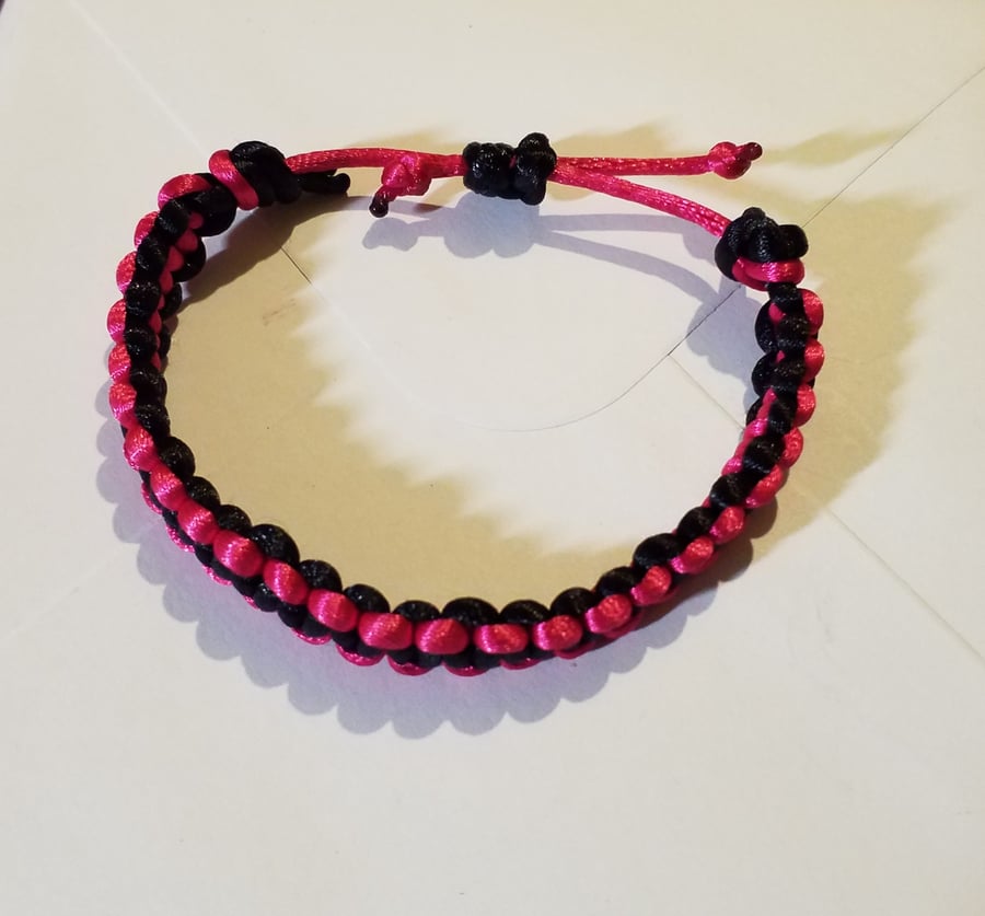 Handmade bright pink and black macrame bracelet. Adjustable 