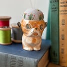 Pin cushion in a vintage dog egg cup embroidered flowers and bee