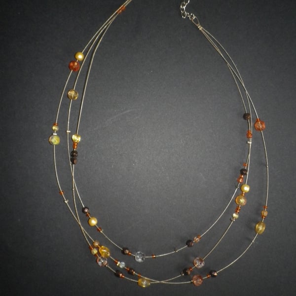 Elegant lightweight triple strand amber and gold informal necklace