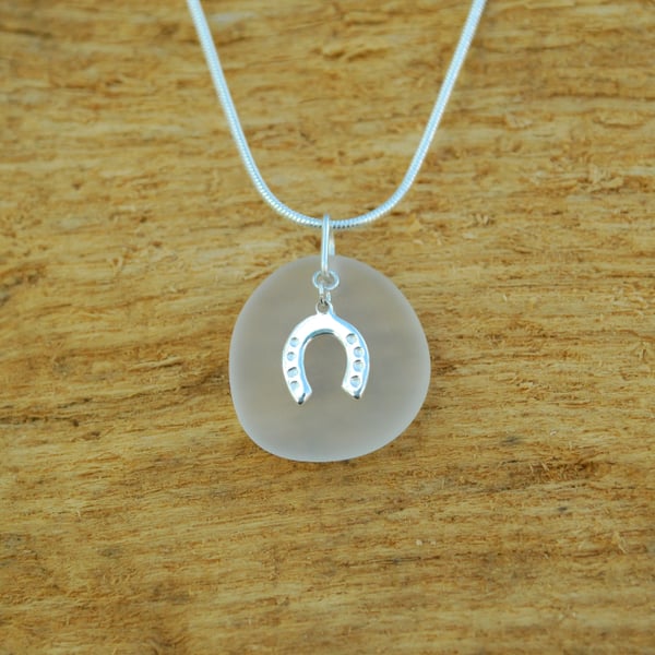 Beach glass pendant with horseshoe charm