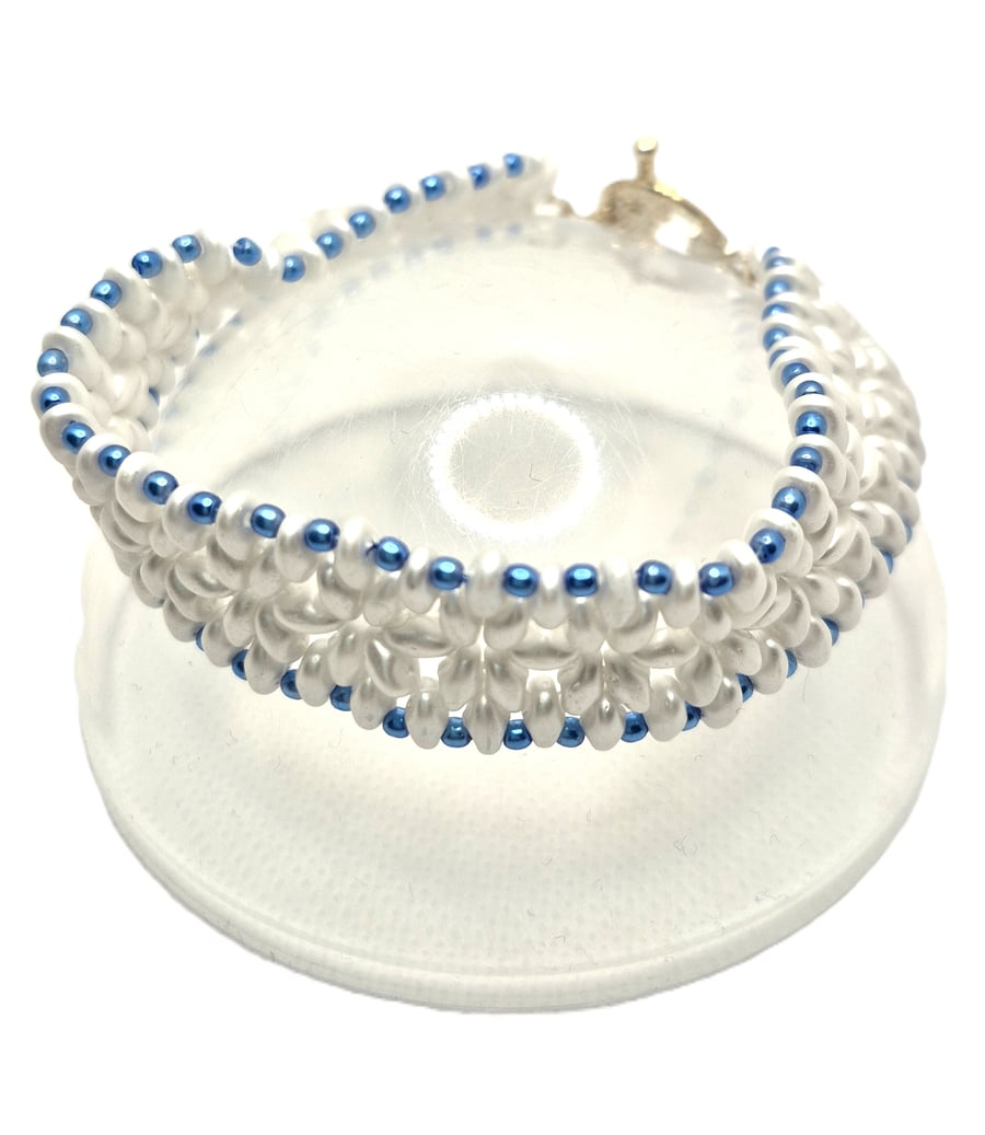 Ladies white beaded bracelet with blue faux pearls