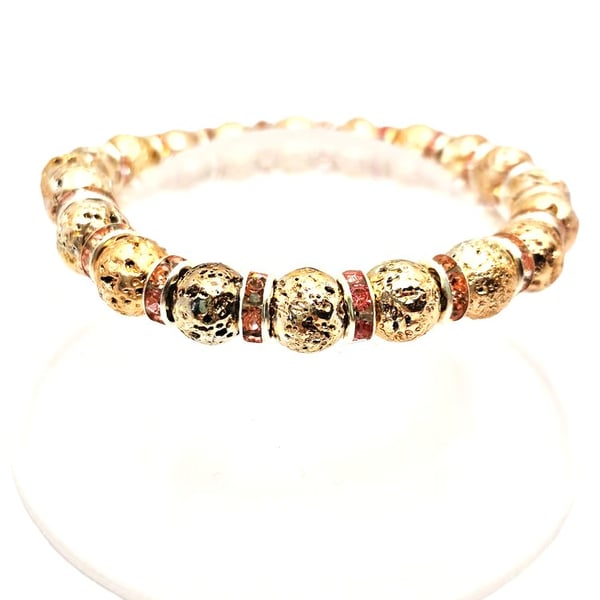 Gold coloured lava beads and pink crystal rondelles stretchy bracelet