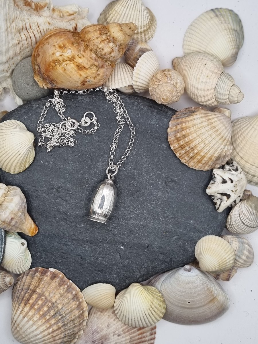 Real poppy seed preserved in silver pendant necklace