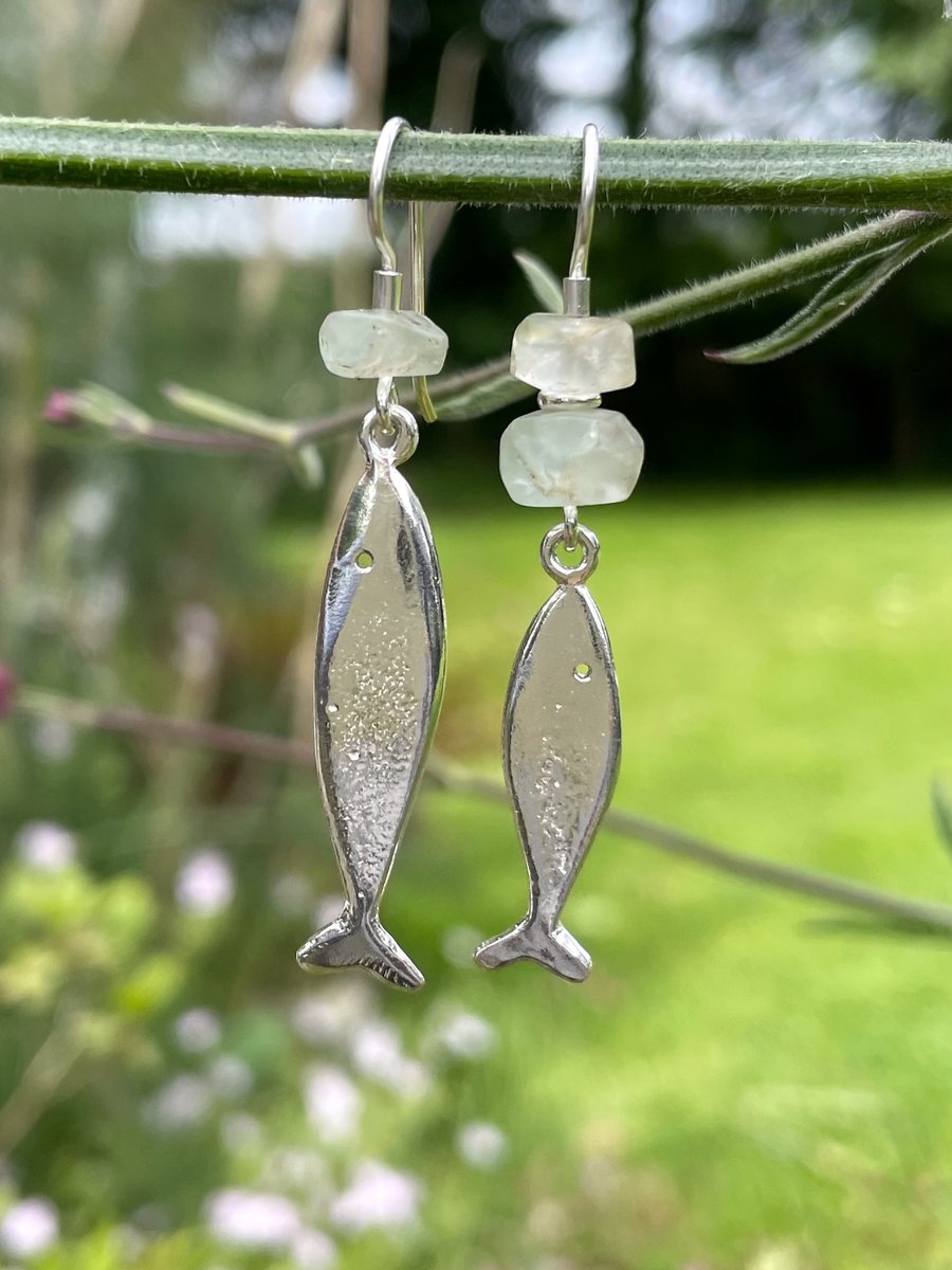 Silver and aquamarine mismatched fish earrings.