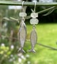 Silver and aquamarine mismatched fish earrings.
