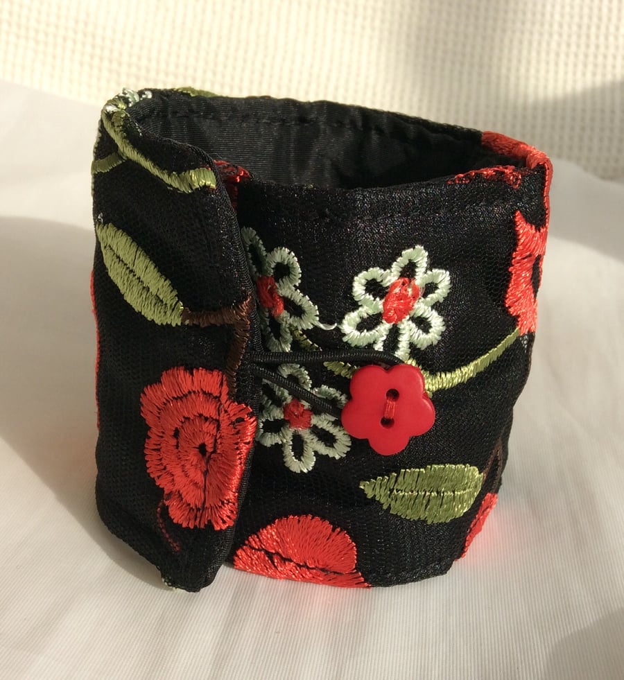 Large wrist cuff, black with red and cream flowers