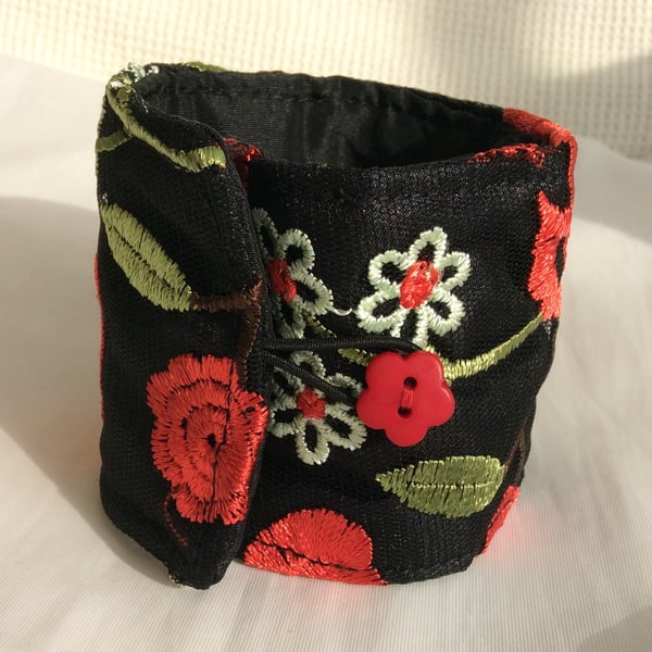 Large wrist cuff, black with red and cream flowers