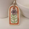 Small ceramic gift tag decoration with flower