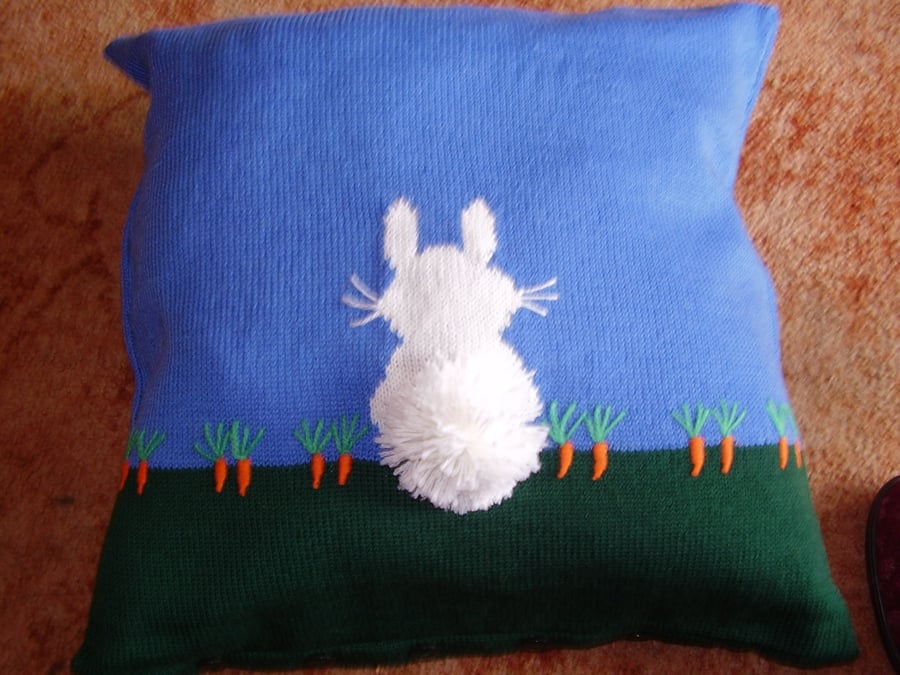 Cushion with a rabbit design. Hand embroidered carrots and bobble tail. 18".