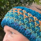 A soft, warm, handknitted, reversible, woolly headband