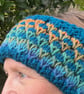 A soft, warm, handknitted, reversible, woolly headband