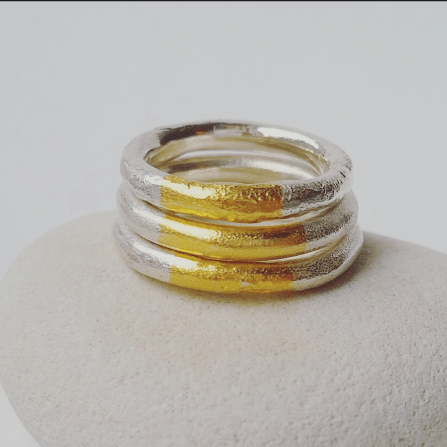 A rustic textured thick silver ring with gold highlight various sizes  