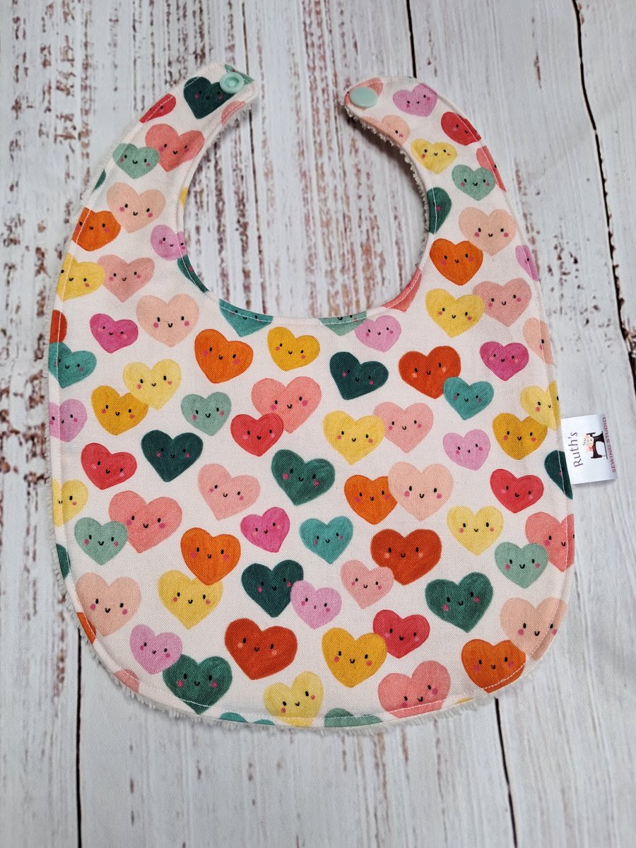 Newborn bamboo baby bib with colourful hearts