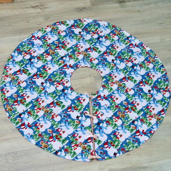 Christmas Tree Skirt with Snowman patterned fabric and ribbon ties. 