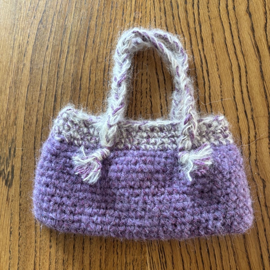 Small crochet handbag in purple and cream with cotton lining