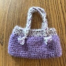 Small crochet handbag in purple and cream with cotton lining