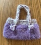 Small crochet handbag in purple and cream with cotton lining
