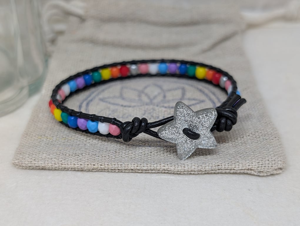 Pride flag beaded bracelet with black leather and star button