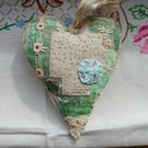 The slow-stitched lavender heart with green and pink stitching