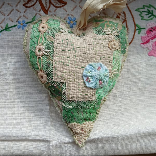The slow-stitched lavender heart with green and pink stitching