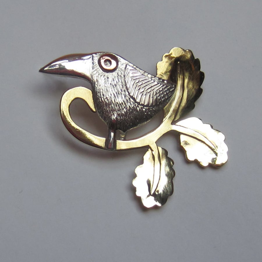 bird brooch with oak leaves