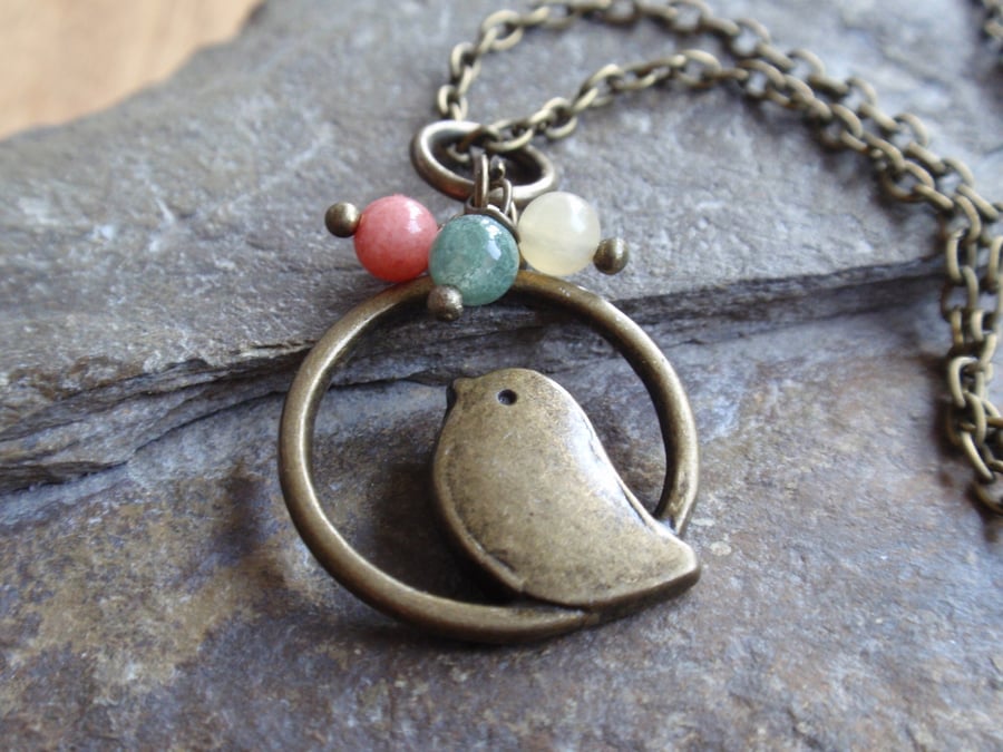 Bronze bird pendant with jade, green aventurine and yellow aragonite gemstones